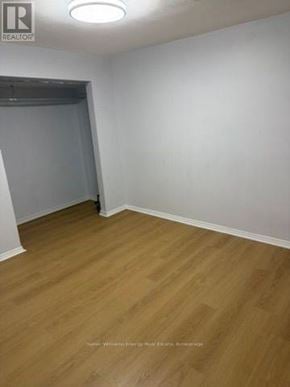 Pickering (West Shore) apartment for rent - A room with wooden flooring and white walls.