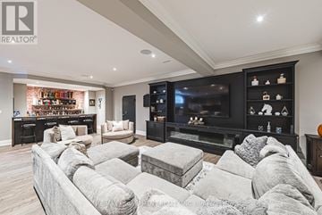 Burlington (Grindstone) apartment for rent - A living room with a grey couch and a black entertainment center.