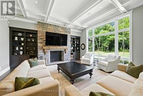 Burlington (Grindstone) apartment for rent - A living room with a stone fireplace and a large flat screen TV.