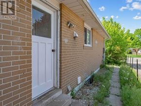 Brampton (Madoc) apartment for rent - A brick house with a white door and a window.