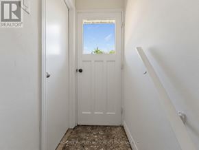 Brampton (Madoc) apartment for rent - A white door with a window above it in a hallway.