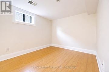 Toronto (Brookhaven-Amesbury) apartment for rent - A room with a window and wooden flooring.