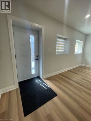 Kitchener apartment for rent - A black doormat with the word "welcome" written on it is in the foreground of a white door.