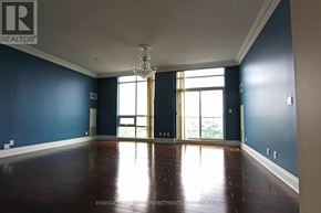 Markham (Unionville) condo for rent - A large empty room with a chandelier and a view of the outside through the windows.