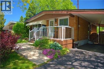 Hamilton apartment for rent - A house with a red brick exterior and a white porch.