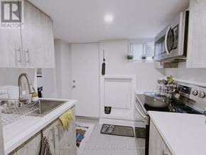 Toronto (Palmerston-Little Italy) apartment for rent - A kitchen with white cabinets and a stainless steel sink.