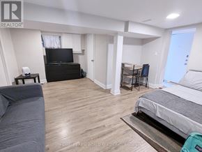 Toronto (Palmerston-Little Italy) apartment for rent - A bedroom with a bed, a couch, and a television.