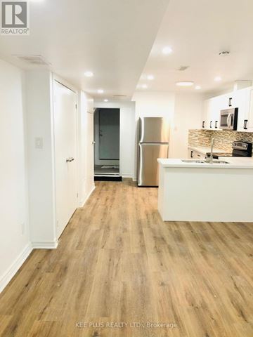 Toronto (South Riverdale) apartment for rent - A kitchen with a refrigerator and a counter top.