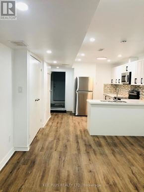 Toronto (South Riverdale) apartment for rent - A modern kitchen with wood flooring and stainless steel appliances.