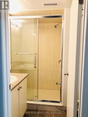 Toronto (South Riverdale) apartment for rent - A bathroom with a glass shower door and a white sink.