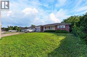 Windsor apartment for rent - A house with a lawn in front of it is for sale.