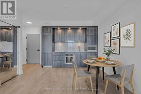 Toronto (Dovercourt-Wallace Emerson-Junction) condo for rent - A modern kitchen with a dining table set for two.