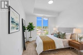 Toronto (Dovercourt-Wallace Emerson-Junction) condo for rent - A bedroom with a large bed and a view of the city.