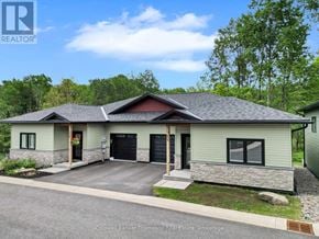 Huntsville (Brunel) apartment for rent - A house with a grey siding and a red roof is for sale.