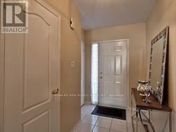 Newmarket (Summerhill Estates) apartment for rent - A hallway with a white door and a mirror on a table.