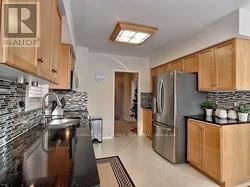 Newmarket (Summerhill Estates) apartment for rent - A kitchen with wooden cabinets and a stainless steel refrigerator.