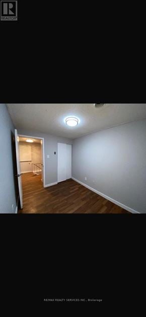 Brampton (Central Park) apartment for rent - A room with a wooden floor and white walls.