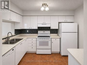 Mississauga (City Centre) condo for rent - A kitchen with white cabinets and appliances.