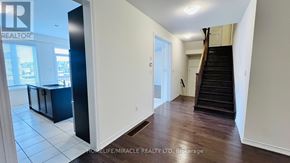 Brampton (Credit Valley) apartment for rent - A spacious room with a staircase leading to the upper floor.