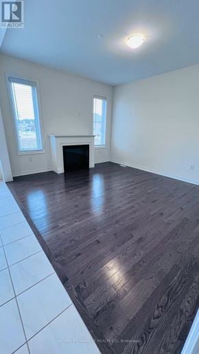 Brampton (Credit Valley) apartment for rent - A room with a fireplace and a tv on the wall.