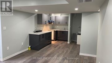 Kitchener apartment for rent - A kitchen with a large island and modern appliances.