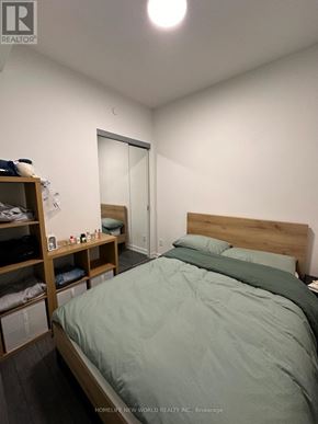 Toronto (Church-Yonge Corridor) condo for rent - A bedroom with a bed, nightstand, and a shelf with various items.