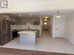 Grey Highlands townhouse for rent - A kitchen with a refrigerator, oven, and sink.