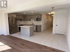 Grey Highlands townhouse for rent - A kitchen with a refrigerator, sink, and cabinets.