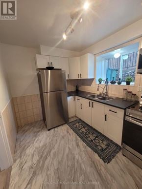 Hamilton (Huntington) multi-family for rent - A kitchen with a refrigerator, sink, and stove.