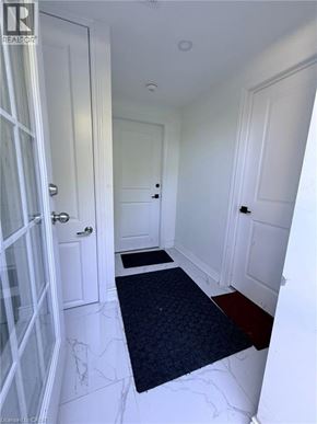 Kitchener apartment for rent - A hallway with a black doormat in the middle.