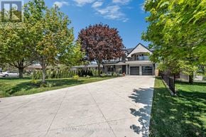 Oakville (Wo West) apartment for rent - A large house with a driveway in front of it.
