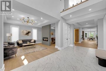 Oakville (Wo West) apartment for rent - A modern living room with a fireplace and a large painting on the wall.