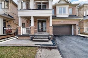 Brampton (Credit Valley) apartment for rent - A house with a brick facade and a large front porch.