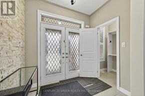 Brampton (Credit Valley) apartment for rent - A white door with a glass window is in the middle of a hallway.