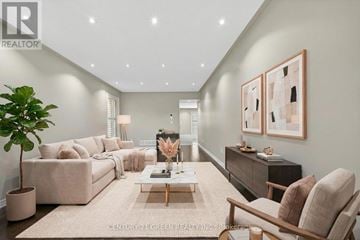 Brampton (Credit Valley) apartment for rent - A well-lit, modern living room with a large sofa, a coffee table, and a side table with a plant.
