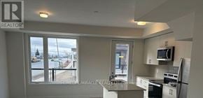 Mississauga (Erin Mills) townhouse for rent - A kitchen with a refrigerator, microwave, and oven.