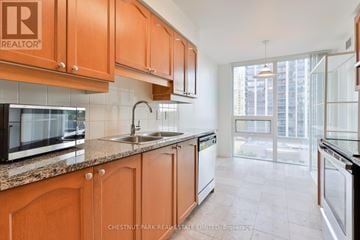 Toronto (Willowdale East) condo for rent - A kitchen with wooden cabinets and a sink.