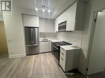 Toronto (Bendale) condo for rent - A kitchen with white cabinets and stainless steel appliances.