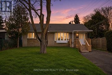 Ottawa apartment for rent - A house with a tree in front of it at dusk.
