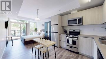 Toronto (Kensington-Chinatown) condo for rent - A modern kitchen with a dining table and chairs.