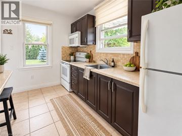 Hamilton apartment for rent - A kitchen with brown cabinets and a white refrigerator.