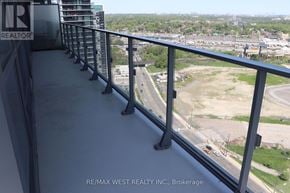 Toronto (Mimico) condo for rent - A balcony with a view of a highway and buildings.