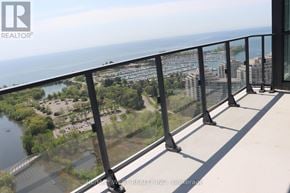 Toronto (Mimico) condo for rent - A balcony with a view of a river and buildings.