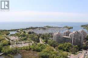 Toronto (Mimico) condo for rent - A bird's eye view of a city with a body of water and apartment buildings.