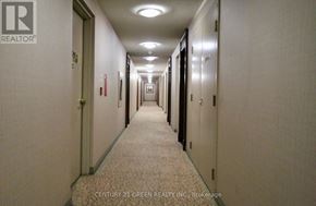 Mississauga (Central Erin Mills) condo for rent - A hallway with a carpeted floor and doors on both sides.