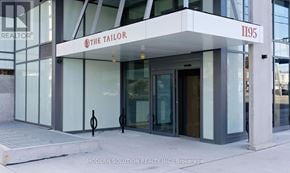 Toronto (Islington-City Centre West) condo for rent - The front of a building with a glass door and a sign that says The Tailor.