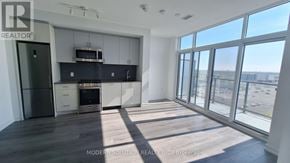 Toronto (Islington-City Centre West) condo for rent - A spacious kitchen with a refrigerator, oven, and microwave.