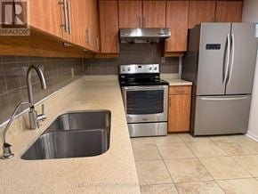 Toronto (Newtonbrook West) condo for rent - A kitchen with a stainless steel refrigerator, oven, and sink.