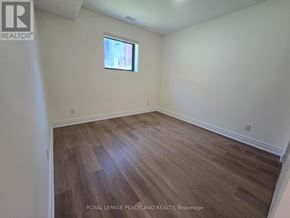 Toronto (University) multi-family for rent - A room with wooden flooring and a window.
