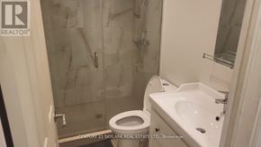 Toronto (Clairlea-Birchmount) apartment for rent - A bathroom with a toilet, sink, and shower.